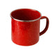 Red speckled enamel mug on a white background